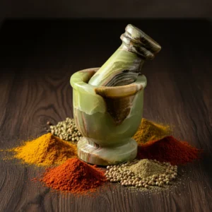 Mini Crusher surrounded by colorful ground spices including turmeric, paprika, coriander seeds and various aromatic spice powders on wooden surface